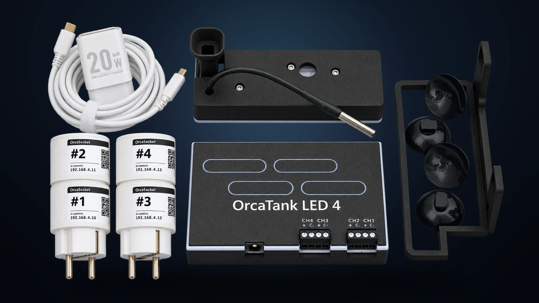Everything in an OrcaTank box: the 20 W GaN USB-C charger and cable, the main unit dock with its temperature probe, four numbered OrcaSocket smart plugs, the OrcaTank LED Driver 4, and the suction-cup mounting bracket